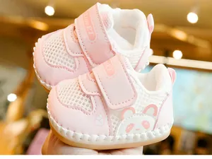 Close-up of pink breathable mesh baby shoes with cute panda pattern and velcro strap