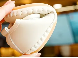 Macro detail of soft cream baby shoes showing high flexibility and premium stitching