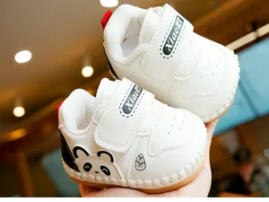 Detailed view of baby walking shoes featuring cute panda embroidery and secure velcro straps