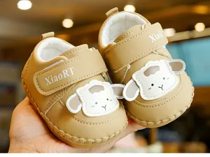 Detail of baby walking shoes with leather material and cute 3D cartoon sheep design
