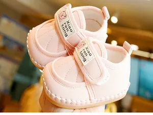 Close-up of pink baby walker shoe featuring soft leather, bear pattern and velcro strap