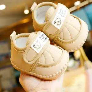 Soft-soled beige baby walking shoes with cute bear pattern and velcro straps