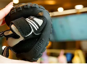 Flexible non-slip rubber sole of toddler shoes shown with bending motion for comfort