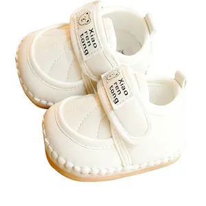 White soft-soled baby walking shoes with non-slip design and cute cartoon bear velcro strap