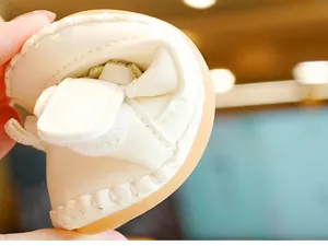 Close-up of flexible soft-sole baby shoes showing high elasticity and durable stitching