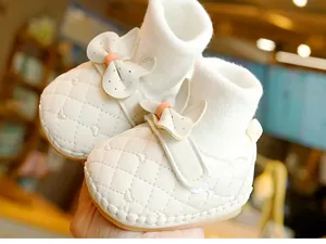 Detailed macro view of cream baby walker boot with heart embroidery and quilted leather
