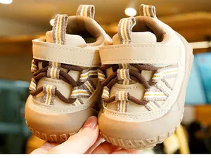 Detail of baby walking shoe with hook-and-loop closure and reinforced rubber toe cap