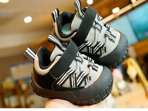 Detail of baby toddler sneakers featuring velcro closure and non-slip rubber outsole