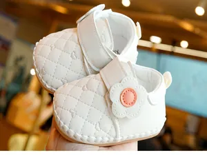 Detailed view of white baby walking shoe with quilted hearts and anti-slip soft sole
