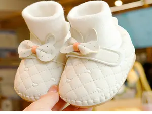 Close-up of white baby walker shoes with heart embroidery and cute rabbit ears decoration