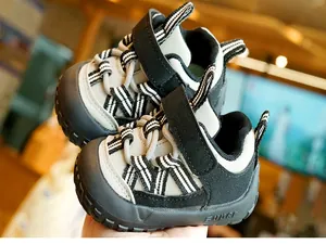 Detail of baby walking shoes with wide velcro strap and non-slip rubber toe cap