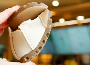 Detailed view of flexible anti-slip rubber sole on soft beige toddler shoes