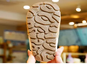 Detail of baby shoe rubber sole with anti-slip wavy patterns and size engraving