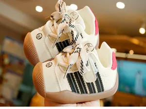 Close-up of non-slip rubber sole and striped leather detail on infant toddler shoes