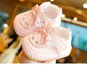 Detail of pink baby Mary Janes with laser-cut petals and non-slip rubber soles