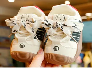 Detail of baby walking shoes with breathable mesh, beige stripes and anti-slip rubber sole