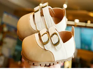 Detail of dual-strap toddler Mary Jane shoes with non-slip soles and bronze buckles