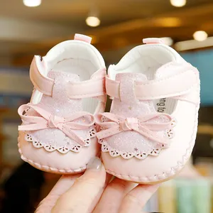 Pink glitter baby princess shoes with soft non-slip soles and bow detail for first steps