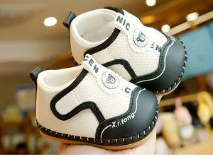 Detail of baby walking shoes showing breathable mesh and cute polar bear logo