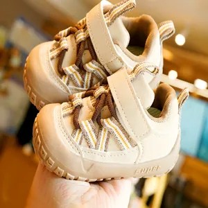 Toddler walking shoes with non-slip rubber soles and velcro straps in beige color