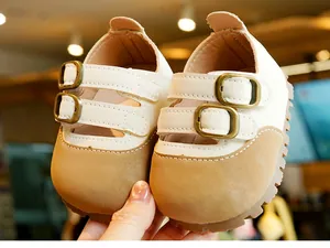 Detail of baby Mary Jane walking shoes featuring dual bronze buckles and anti-slip rubber soles