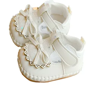 White baby girl toddler shoes with soft non-slip sole, sequins, lace, and bow design