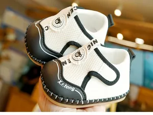 Close-up of soft-sole baby walking shoes featuring breathable mesh and bear logo