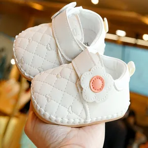 Quilted cream baby walking shoes with soft soles and decorative floral velcro straps