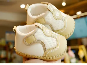 Detailed macro view of breathable mesh baby walker shoes with Velcro strap and bear logo