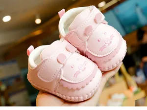 Close-up of pink baby pre-walker shoes with 3D rabbit ears and soft leather texture