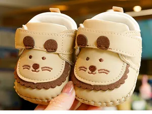Detail view of baby walker shoes with cute cartoon bear ears and soft sole stitching