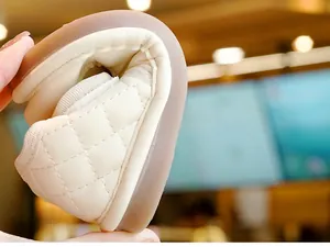 Dettaglio della suola in gomma flessibile sulle scarpe da primi passi beige trapuntate