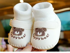 Nahaufnahme von weichen Baby-Lauflernschuhen mit süßer Bärenstickerei und Klettverschluss