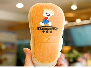 Detailed macro view of non-slip orange rubber sole for infant walking shoes