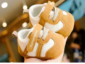 Detail view of yellow baby walking shoes with soft non-slip soles and velcro straps