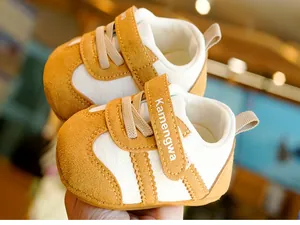 Close-up of brown suede baby walking shoes with double velcro straps and soft sole