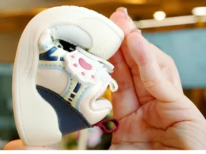 Detail view of baby toddler shoes showing the flexible soft sole during a bending test
