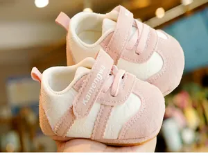 Detail of pink soft-sole baby walking shoes with Velcro strap and non-slip rubber bottom