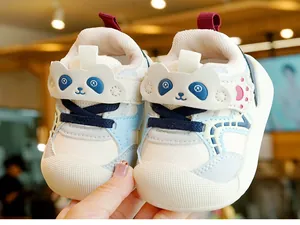 Detailed close-up of baby walking shoes with panda velcro and rubber toe protection