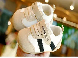 Detail of baby walking shoes with non-slip soft rubber sole and velcro closure