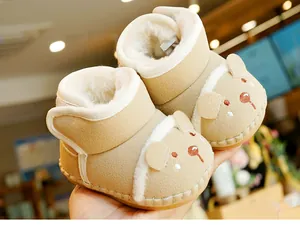 Close-up of baby winter boots with cute bear design and warm thickened plush lining
