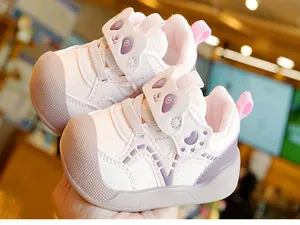 Detail of pink toddler walking shoes with cartoon panda strap and breathable mesh material
