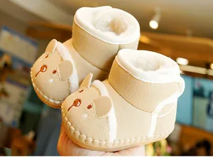 Close-up of soft brown baby boots with cute bear embroidery and thick fleece lining