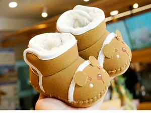 Close-up of baby winter snow boots with warm fleece lining and cute bear embroidery