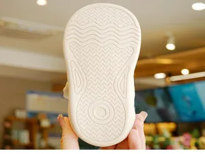 Detailed view of non-slip rubber sole with wave patterns for toddler walking shoes