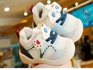 Close-up of winter baby walking shoes with panda cartoon motif and warm fleece lining