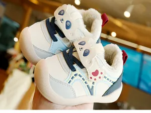Detail of warm winter toddler shoes with plush lining and cute panda cartoon design