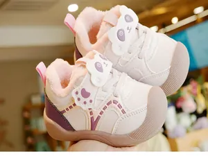Close-up of winter baby walking shoes with plush lining and cute panda velcro strap