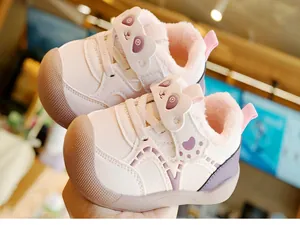 Detail of baby winter shoe showing plush lining and cute cartoon panda ear design