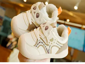 Close-up of winter baby walking shoes with plush lining and cute panda velcro strap